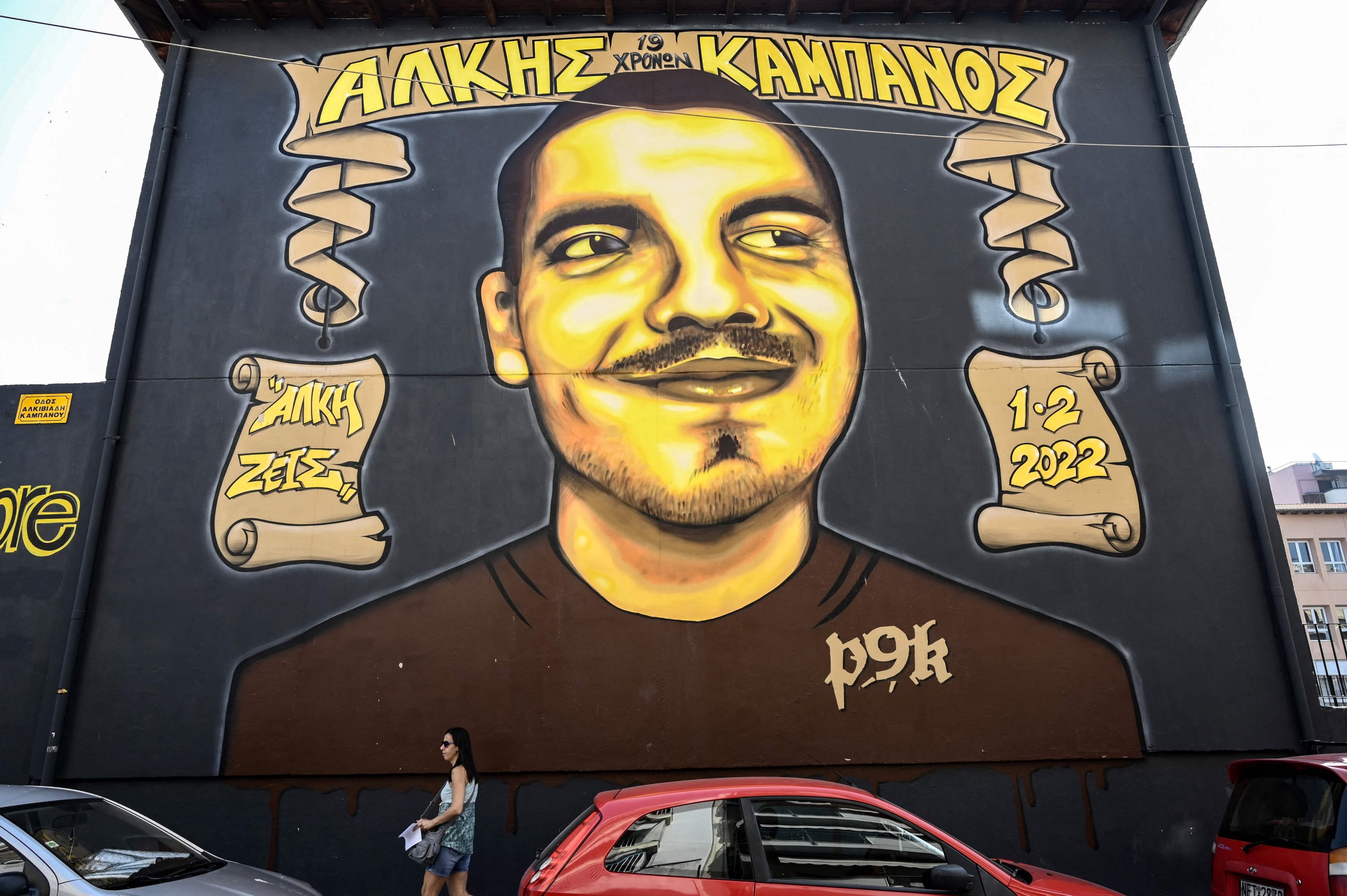 282265 A woman walks past a mural bearing a portrait of the late football fan Alkis Kampanos, near the place he was killed by young hooligans, Thessaloniki, Greece, July 12, 2023. (AFP Photo)