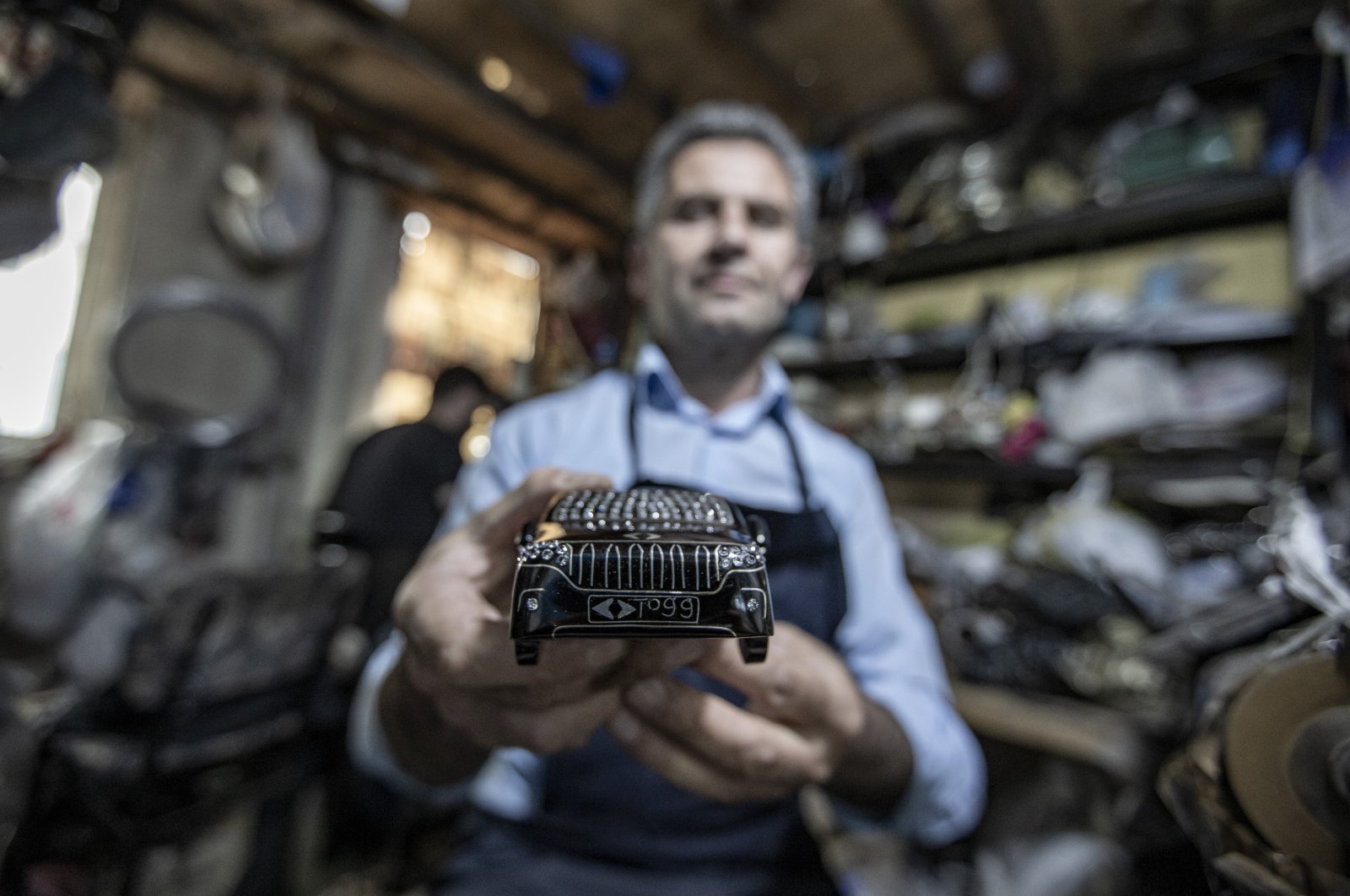Süleyman Yavuz exhibits a carved model of Türkiye's first indigenous car Togg, Erzurum, eastern Türkiye, July 13, 2023. (AA Photo)