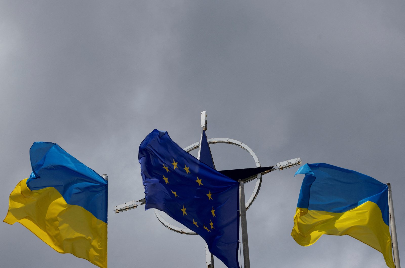 National flags of Ukraine and the European Union rise in front of the NATO emblem, amid Russia's attack on Ukraine, in central Kyiv, Ukraine, July 11, 2023. (Reuters Photo)