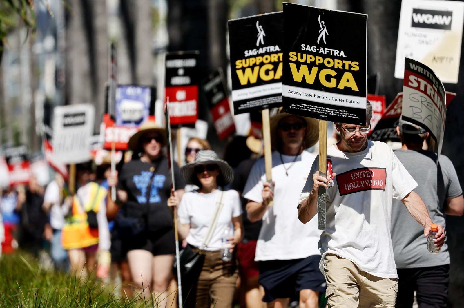 A sign reads "SAG-AFTRA Supports WGA" as SAG-AFTRA members walk the picket line in solidarity with striking WGA (Writers Guild of America) workers outside Netflix offices in Los Angeles, California, U.S., July 13, 2023. (AFP Photo)