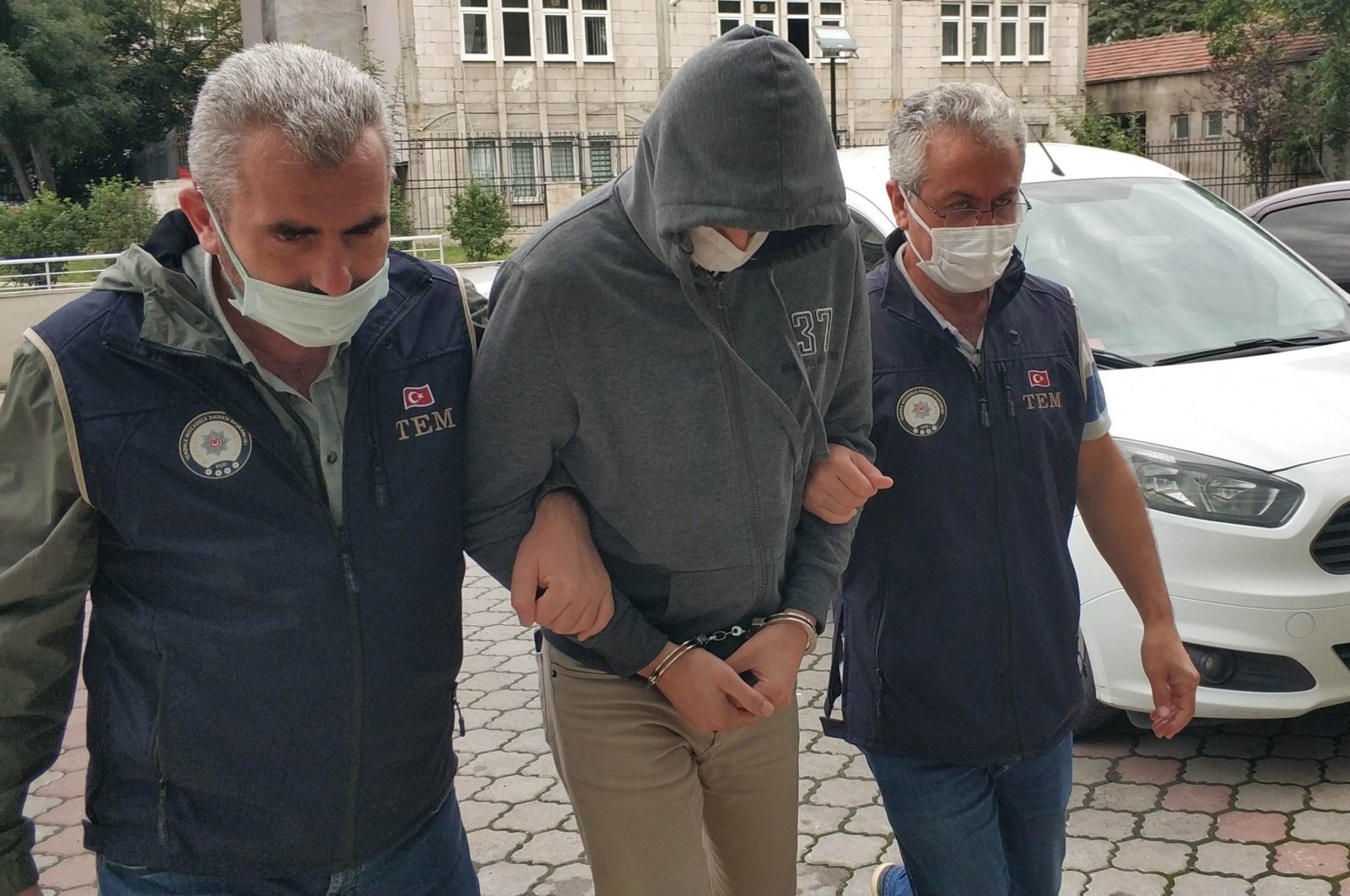 Police escort a FETÖ suspect captured in an operation in Denizli, western Türkiye, March 20, 2023. (İHA Photo)
