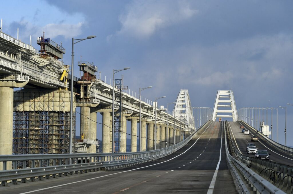 Cars and other vehicles drive on the Crimean Bridge connecting the Russian mainland and the Crimean peninsula, Feb. 23, 2023. (AP Photo)