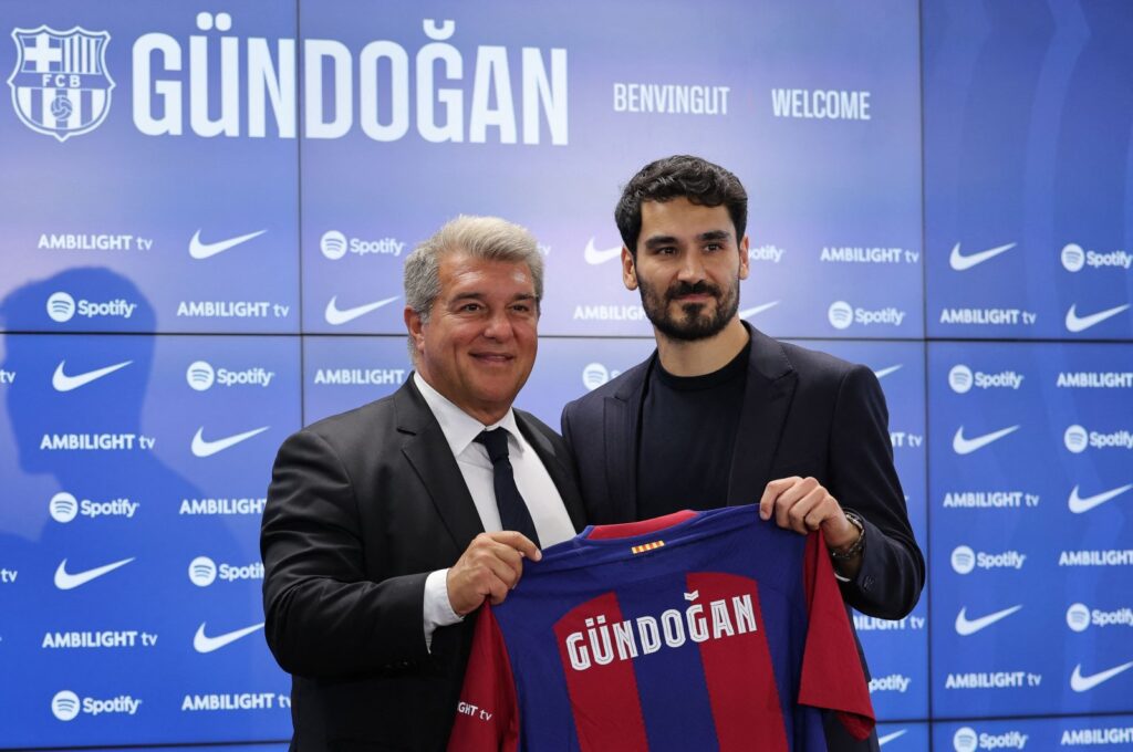 FC Barcelona's newly-signed German midfielder Ilkay Gundogan (R) poses for pictures with FC Barcelona's President Joan Laporta holding his jersey during his official presentation at the Joan Gamper training ground in Sant Joan Despi, Barcelona, Spain, July 17, 2023. (AFP Photo)
