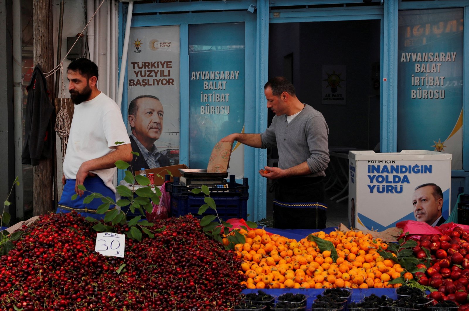 Vendors stand in their stall outside a local office of President Tayyip Erdoğan's ruling Justice and Development Party (AK Party), ahead of the May 28 runoff vote, at a fresh market in Istanbul, Türkiye, May 23, 2023. (Reuters Photo)