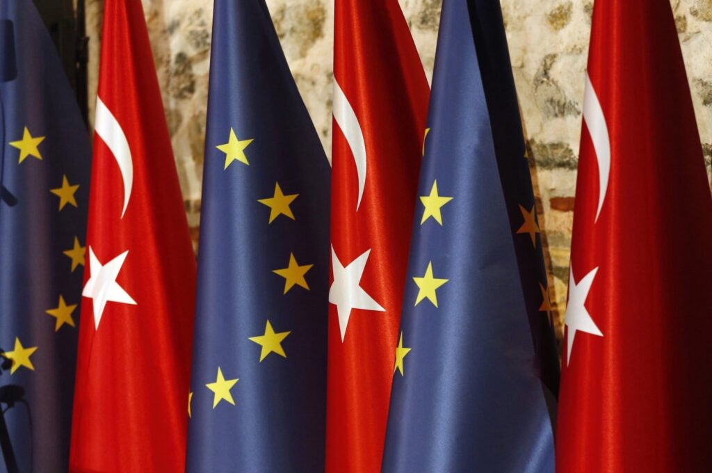 An official adjusts Turkish and European Union flags prior to the opening session of a high-level meeting between the EU and Türkiye, in Istanbul, Thursday, Feb. 28, 2019. (AP File Photo)