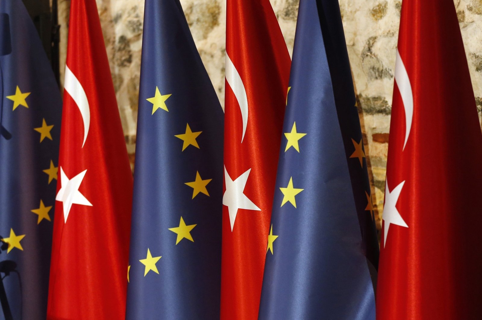 An official adjusts Turkish and European Union flags prior to the opening session of a high-level meeting between the EU and Türkiye, in Istanbul, Thursday, Feb. 28, 2019. (AP File Photo)