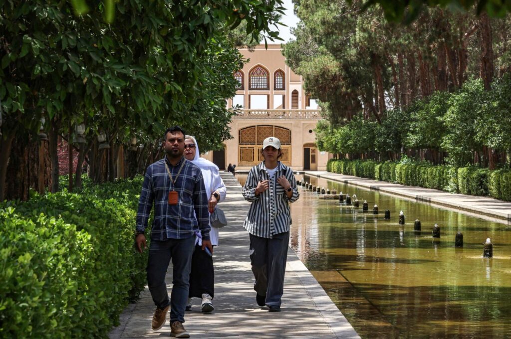 A guide leads tourists at the Dowlat Abad Garden in Iran's central city of Yazd, Iran, July 3, 2023. (AFP Photo)
