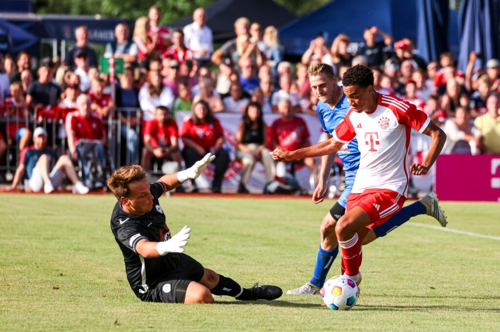 Bayern Munich's Jamal Musiala (R) challenges Rottach-Egern's Mario Weiss during the preseason friendly match, Rottach-Egern, Germany, July 18, 2023. (Getty Images Photo)