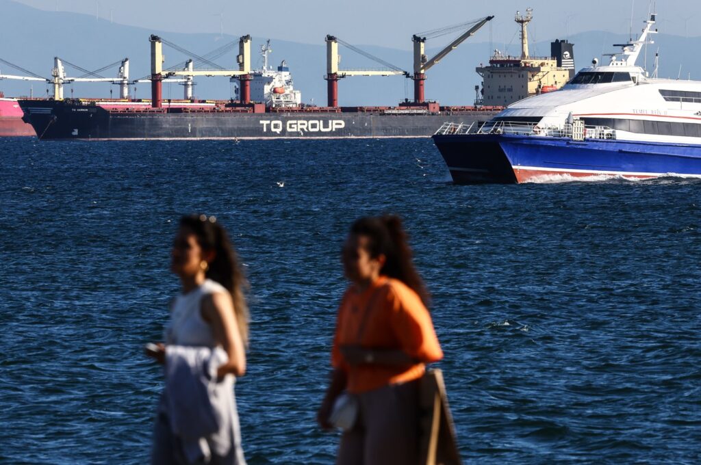 Two women pass on the river bank as the Türkiye-flagged TQ Samsunhe, the last grain ship that left a Ukrainian port since Russia exited the grain corridor agreement one day earlier, is seen in the Marmara Sea, in Istanbul, Türkiye, July 18, 2023. (EPA Photo)