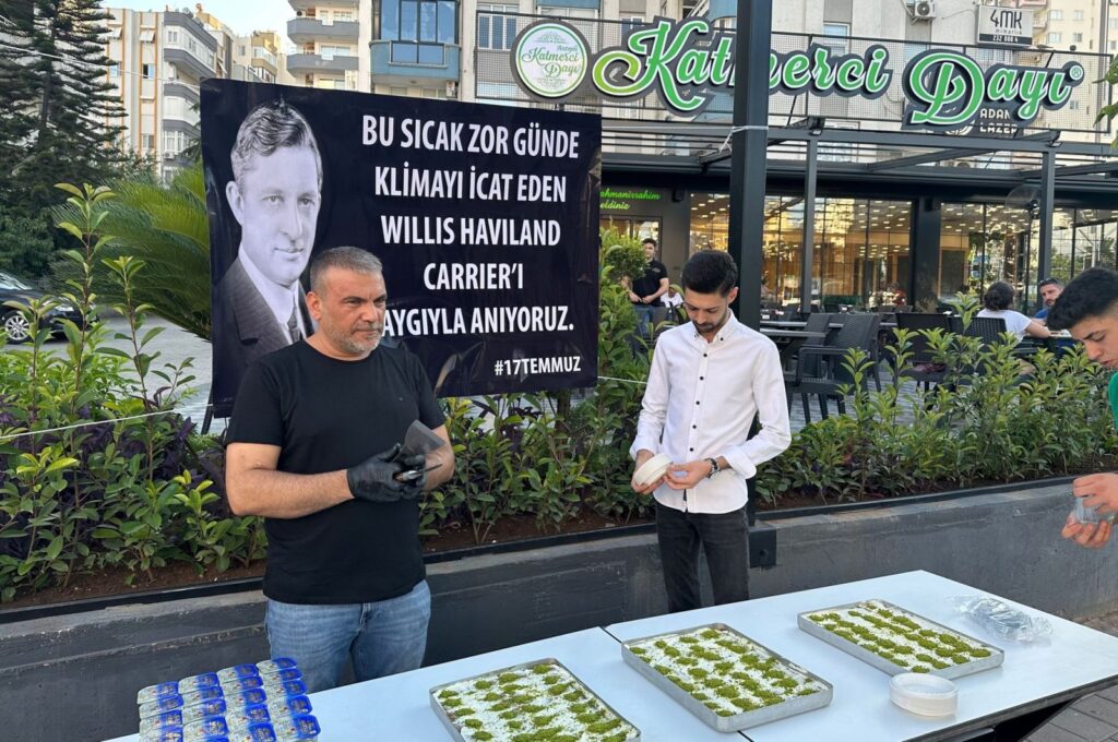 A citizen distributes dessert in memory of the inventor of the air conditioner, U.S. engineer Willis Haviland Carrier in Çukurova, Adana, Türkiye, July 19, 2023. (AA Photo)