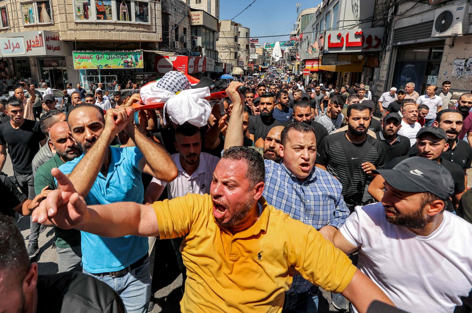 Mourners carry the body of Palestinian Bader al-Masri, who was killed while the Israeli army was securing "the coordinated entrance of Israeli civilians to Joseph's Tomb", during the funeral in the city of Nablus in the north of the occupied West Bank, Palestine, July 20, 2023. (AFP Photo)