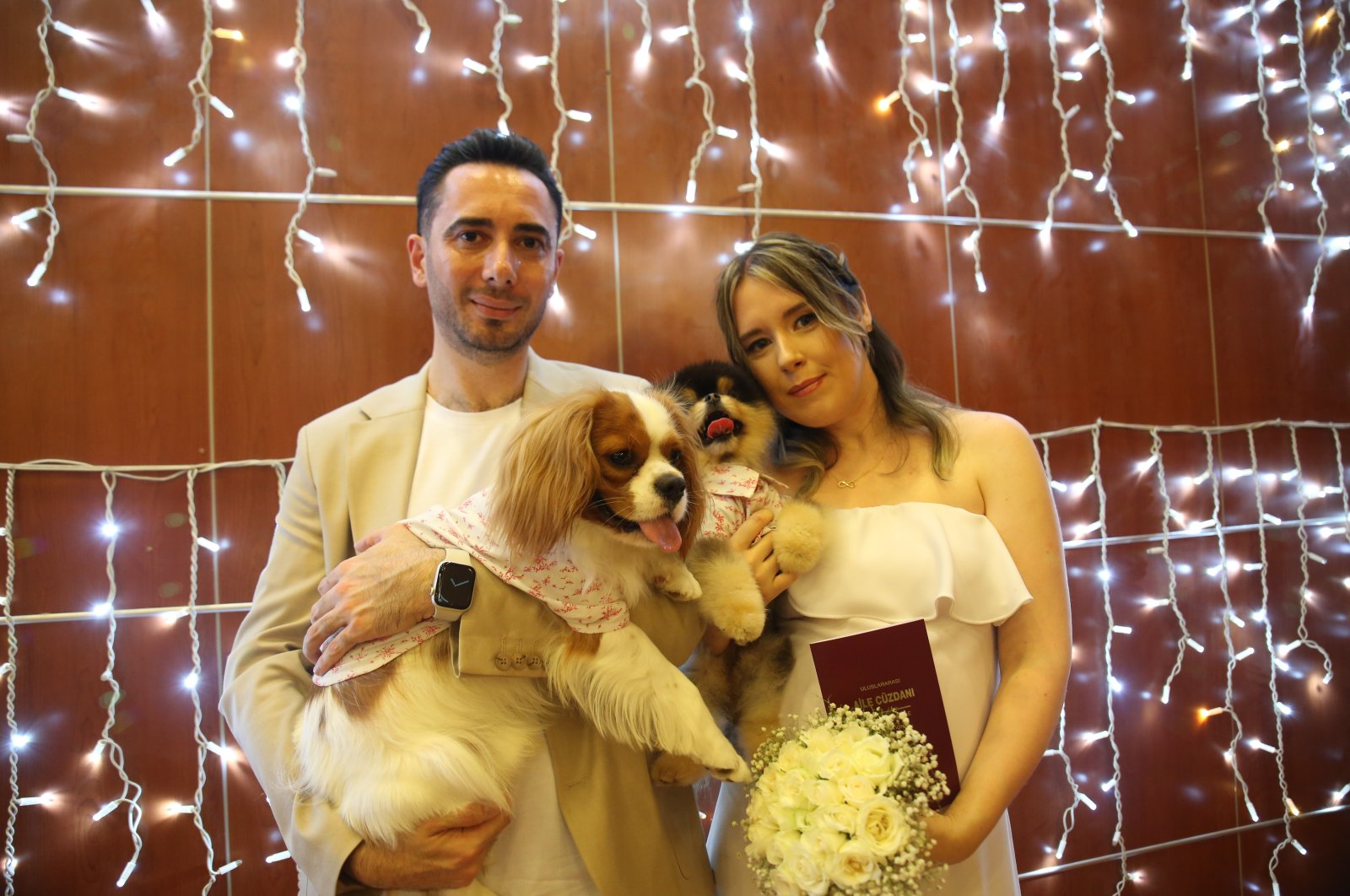 Mete Soyutürk (L) and Daria Soyutürk with their pet dogs pose at their wedding ceremony in Mersin, Türkiye, July 21, 2023. (IHA Photo)
