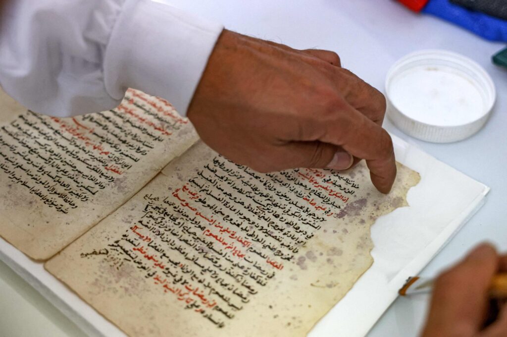 Palestinian restoration expert Rami Salameh works at the manuscript restoration lab at Khalidi Library in East Jerusalem, Palestine, June 17, 2023. (AFP)