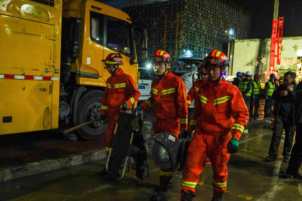 Firefighters transport equipment during a rescue operation at the site where the roof of a school gymnasium collapsed, in Qiqihar, Heilongjiang province, China, July 24, 2023. (Reuters Photo)