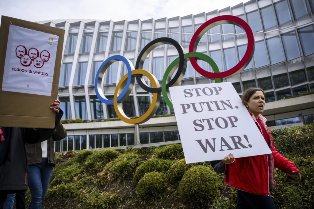 Members of the Geneva branch of Ukrainian society in Switzerland protest during a rally to urge International Olympic Committee to reconsider their decision of participation of Russian and Belarusian athletes under white neutral flag at the next 2024 Paris Olympic Games, in front of the IOC headquarters, Lausanne, Switzerland, March 25, 2023. (AP Photo)
