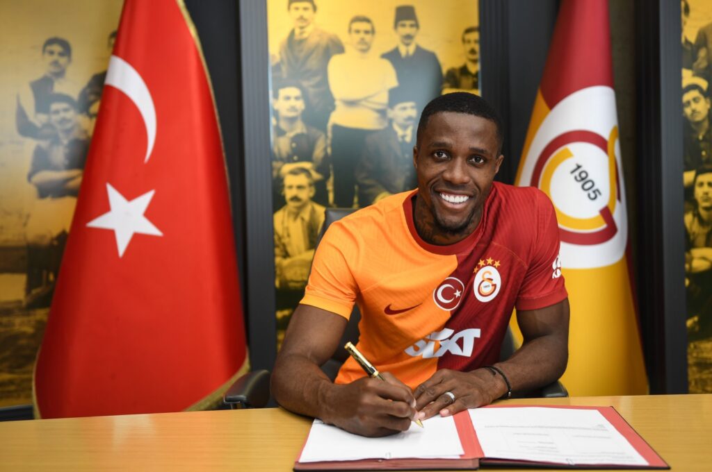 Galatasaray's new signing Wilfried Zaha signs the contract on his arrival from Crystal Palace, Istanbul, Türkiye, July 24, 2023. (AA Photo)