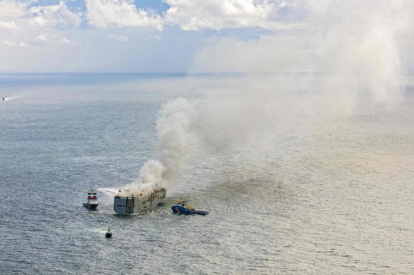 This aerial photograph shows emergency boats extinguishing a fire aboard the Panamanian-registered car carrier cargo ship Fremantle Highway, off the coast of the northern Dutch island of Ameland. (AFP Photo)