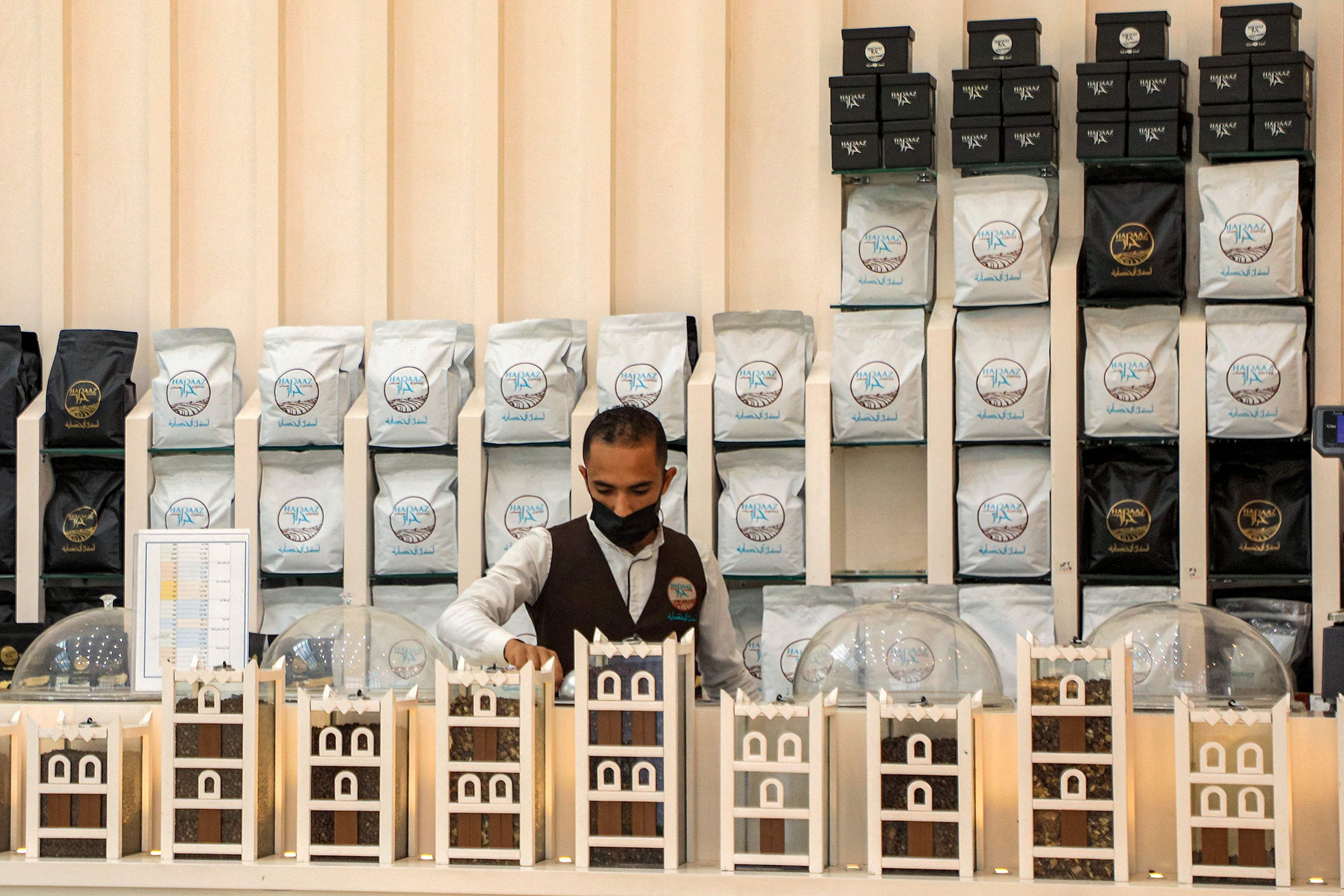 284602 A speciality coffee shop employee packages and sells coffee at the shop's counter in Yemen's Huthi-held capital Sanaa, Yemen's Houthi-held capital, July 23, 2023. (AFP Photo)