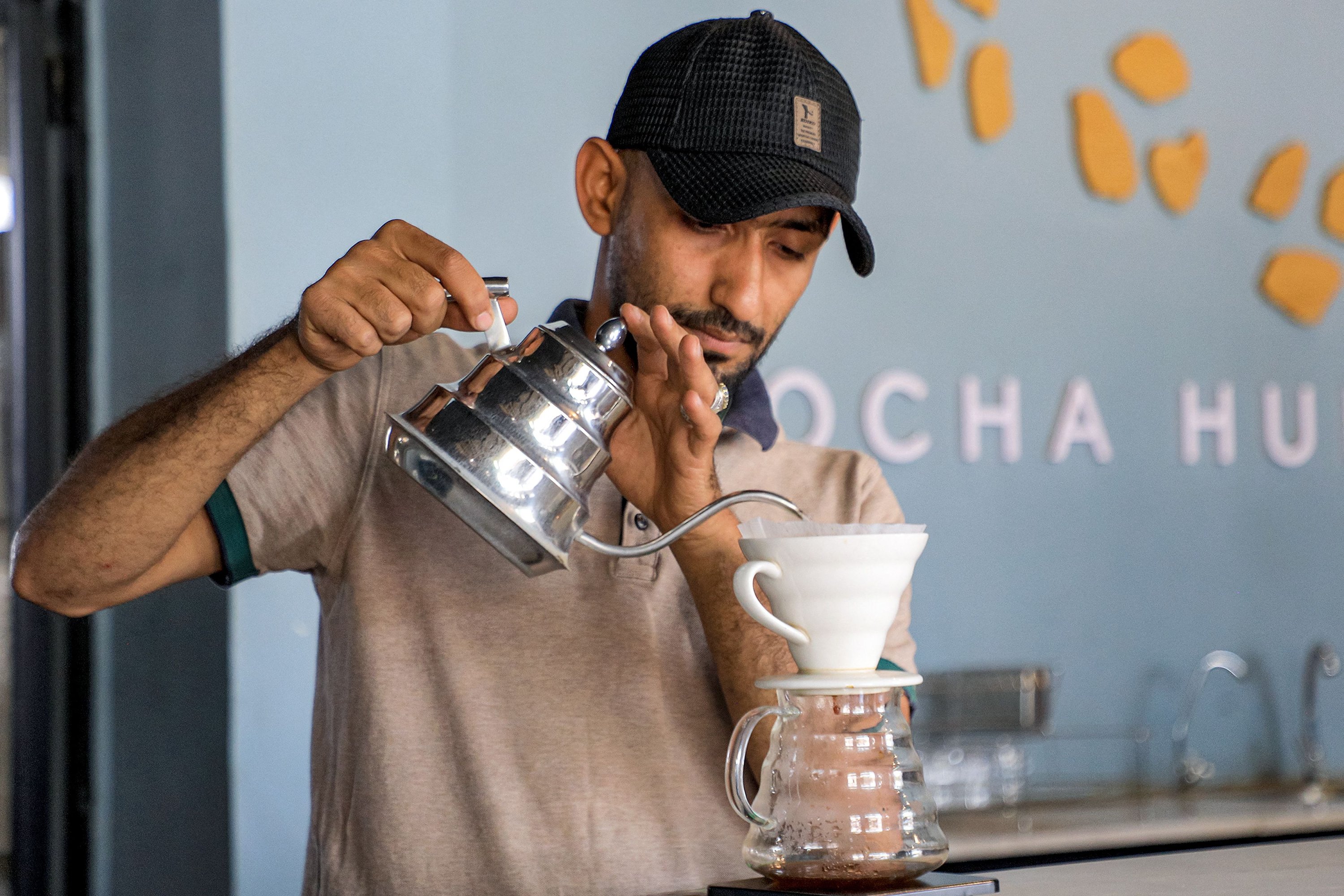 284603 A speciality coffee shop employee serves filtered coffee at the shop in Yemen's Huthi-held capital Sanaa, Yemen's Houthi-held capital, July 23, 2023. (AFP Photo)