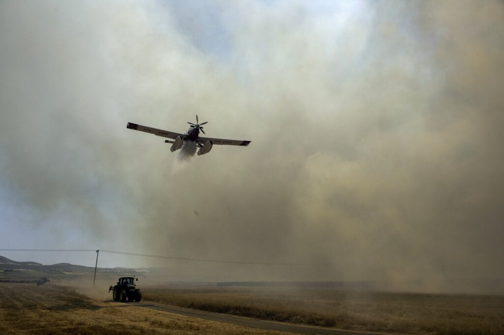 A firefighting aircraft drops water during a fire in Velestino, Magnesia prefecture, Greece, July 27, 2023. (EPA Photo)