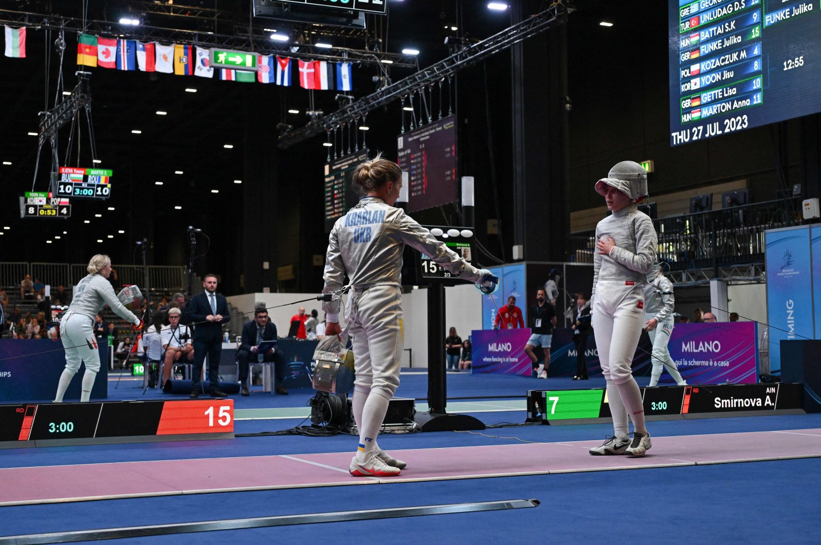 Ukraine's Olha Kharlan (L) gestures as she refuses to shake hands with Russia's Anna Smirnova, registered as an Individual Neutral Athlete (AIN), after she defeated her during the Sabre Women's Senior Individual qualifiers, as part of the FIE Fencing World Championships at the Fair Allianz MI.CO, Milan, Italy, July 27, 2023. (AFP Photo)