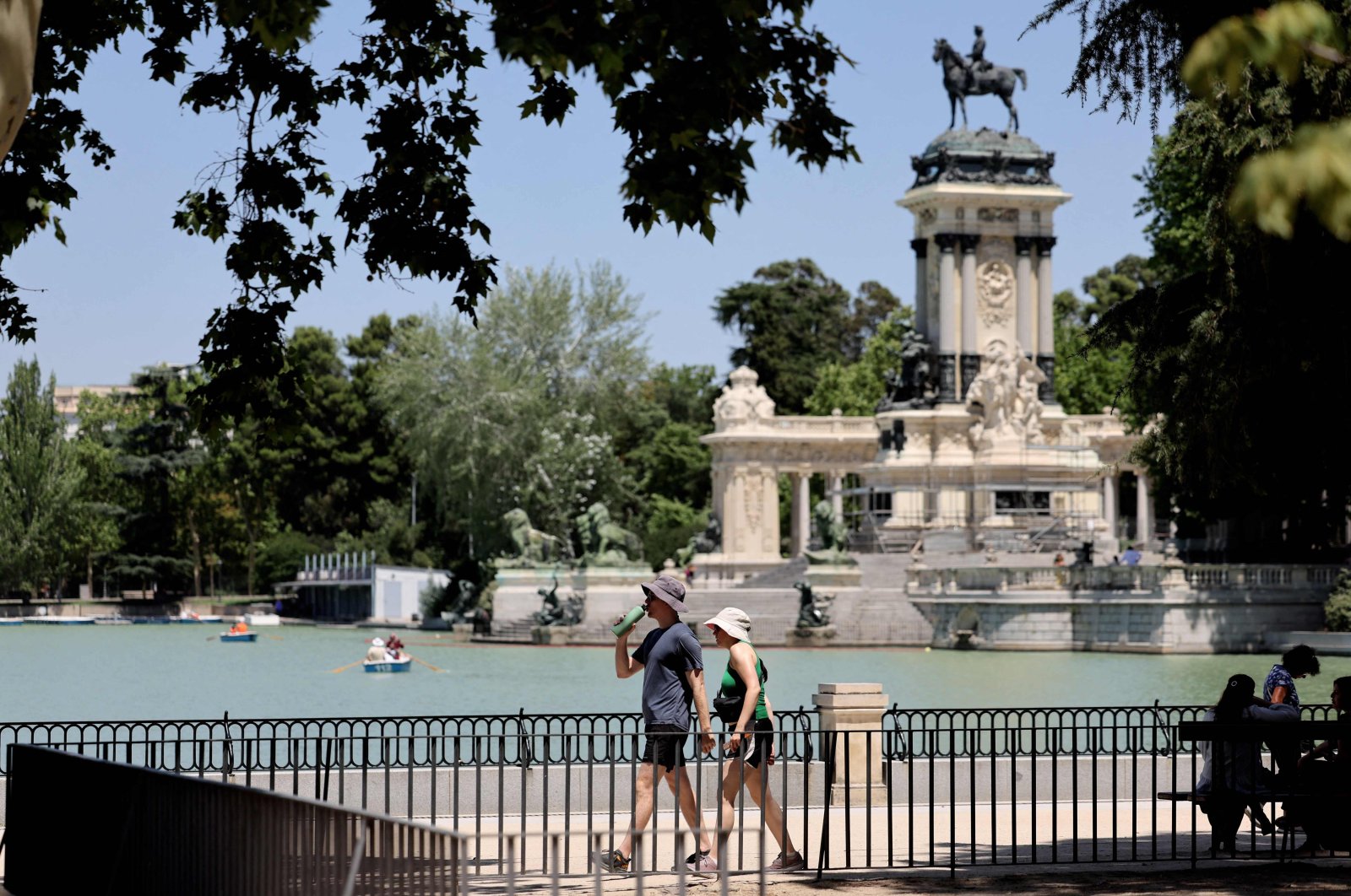 People drink water as they visit the Retiro Park in Madrid, Spain, July 11, 2023. (AFP Photo)