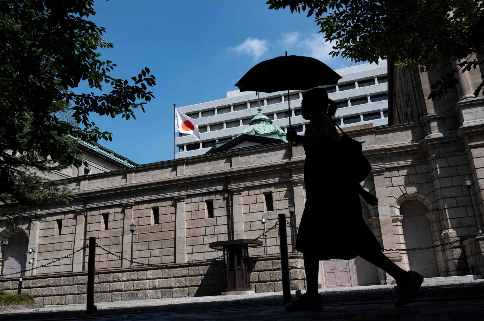 A pedestrian walks past the Bank of Japan building in central Tokyo, Japan, July 28, 2023. (AFP Photo)