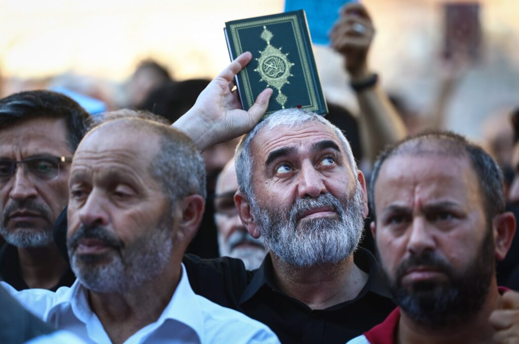 A protester holds a copy of the Quran as they attend a protest against Sweden for allowing anti-Muslim right-wing extremists to desecrate and burn copies of the Muslim holy book in Stockholm and Copenhagen, in front of the Consulate General of Sweden in Istanbul, Türkiye, July 30, 2023. (EPA Photo)