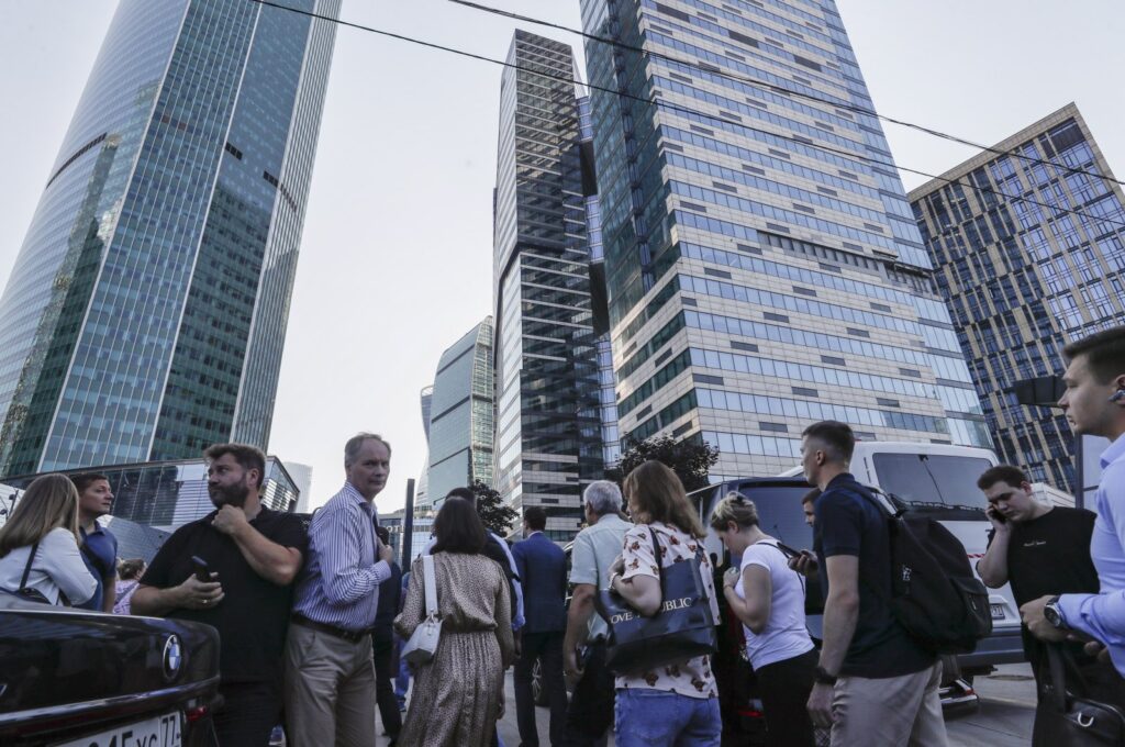 People walk near a damaged building in the Moskva-City business center following a reported drone attack in Moscow, Russia, August 1, 2023. (EPA Photo)