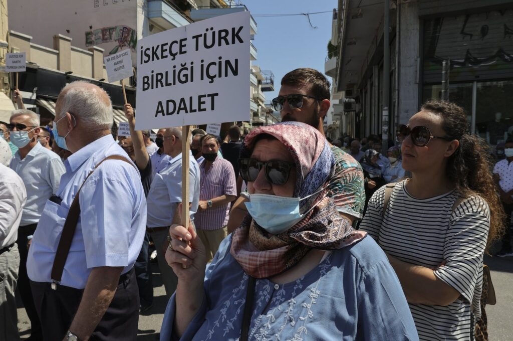 A Turkish Greek woman holds up a sign that reads "Justice for Turkish community of Iskeçe (Xanthi)" during a protest against the Greek Supreme Court's rejection of the community's reregistration in contravention of European Court of Human Rights (ECtHR) rulings, Western Thrace, Greece, July 12, 2021. (AA Photo)