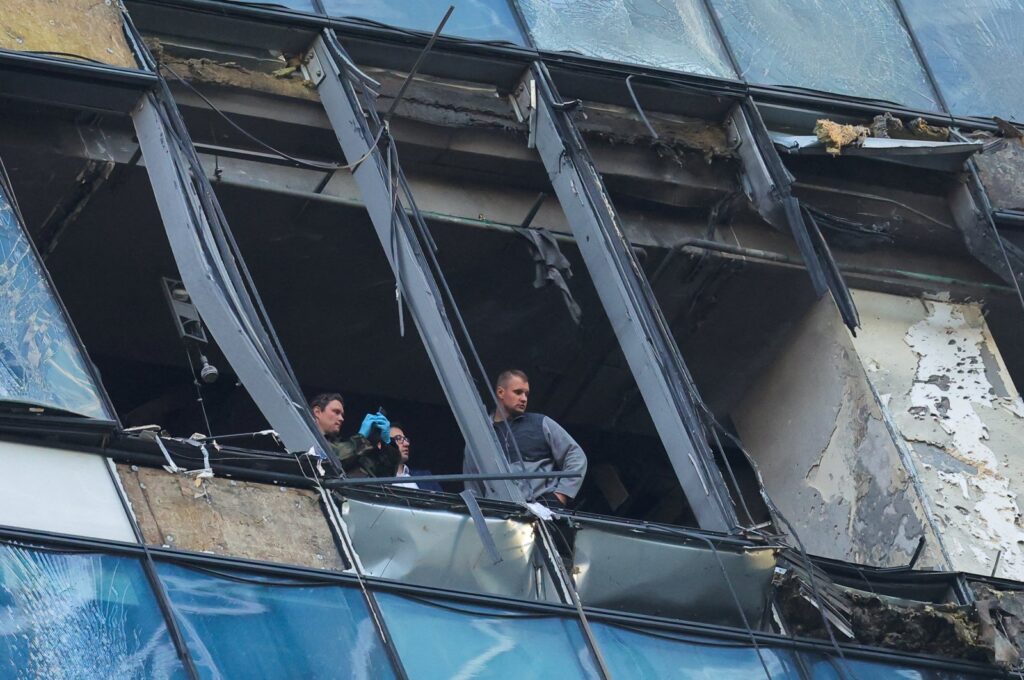 Security services members investigate a damaged office building in Moscow, Russia, Aug. 1, 2023. (Reuters Photo)