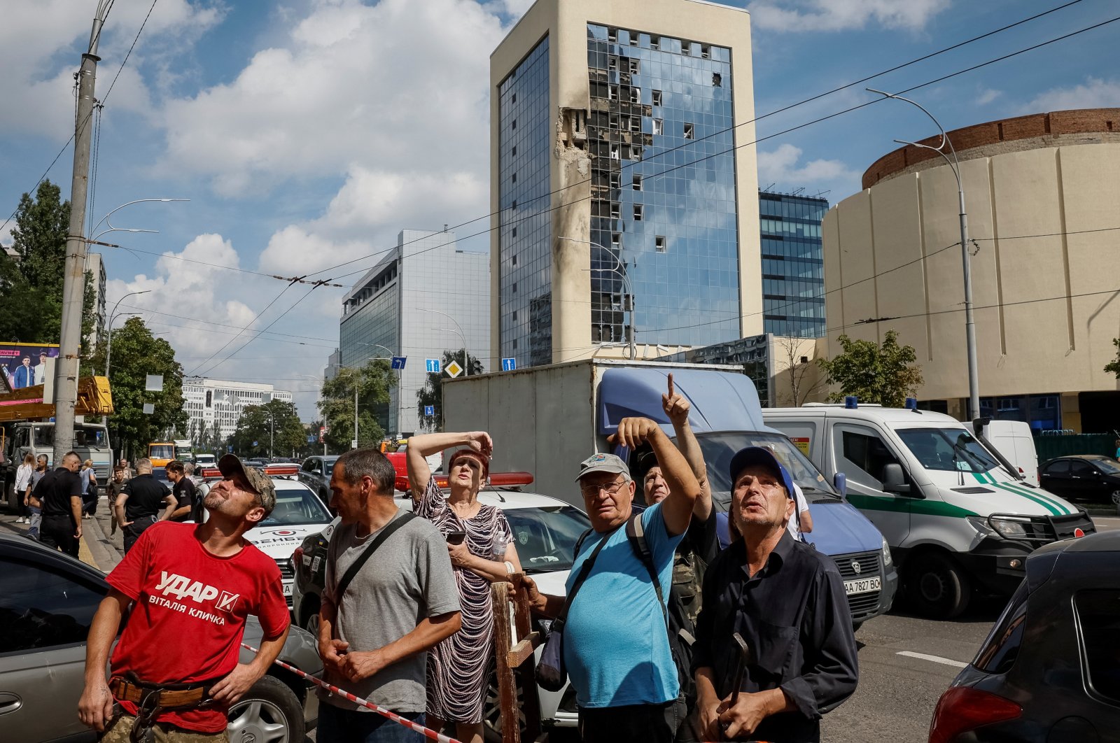 Local residents look on near a building damaged during a Russian drone strike, amid Russia's attack on Kyiv, Ukraine, Aug. 2, 2023. (Reuters Photo)