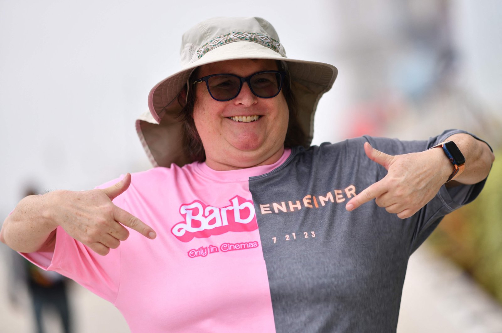 An attendee points at her Barbenheimer shirt outside the convention center during San Diego Comic-Con International in San Diego, California, July 20, 2023. (AFP Photo)