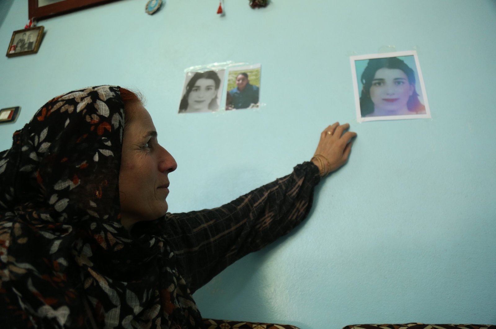 Sabah Anter stares at a photo of her daughter, in Qamishli, Syria, August 3, 2023. (AA Photo)