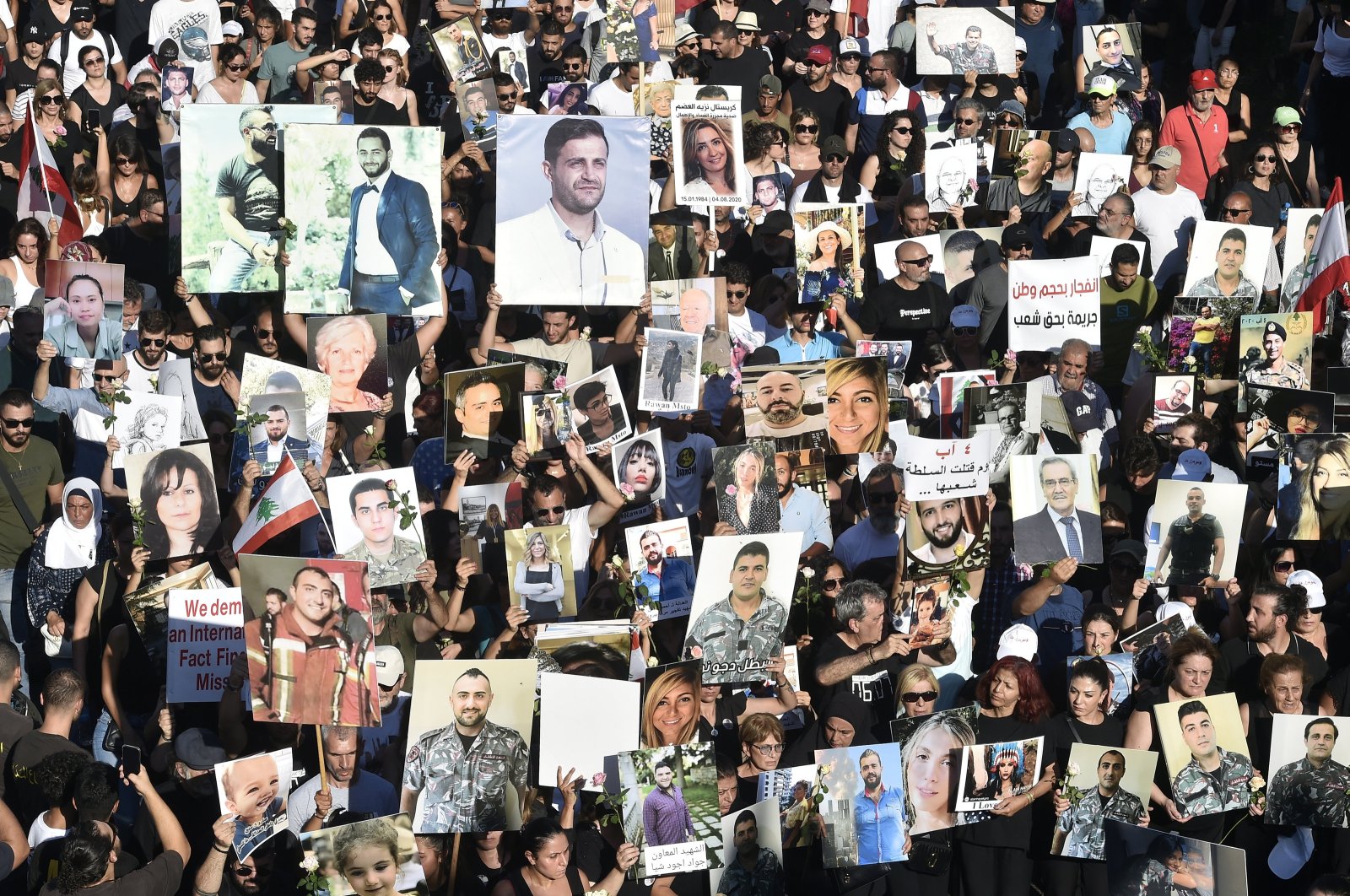 People carry placards and portraits of their deceased relatives during a march to the port to commemorate the third anniversary of the Beirut port explosion, Beirut, Lebanon, Aug. 4, 2023. (EPA Photo)