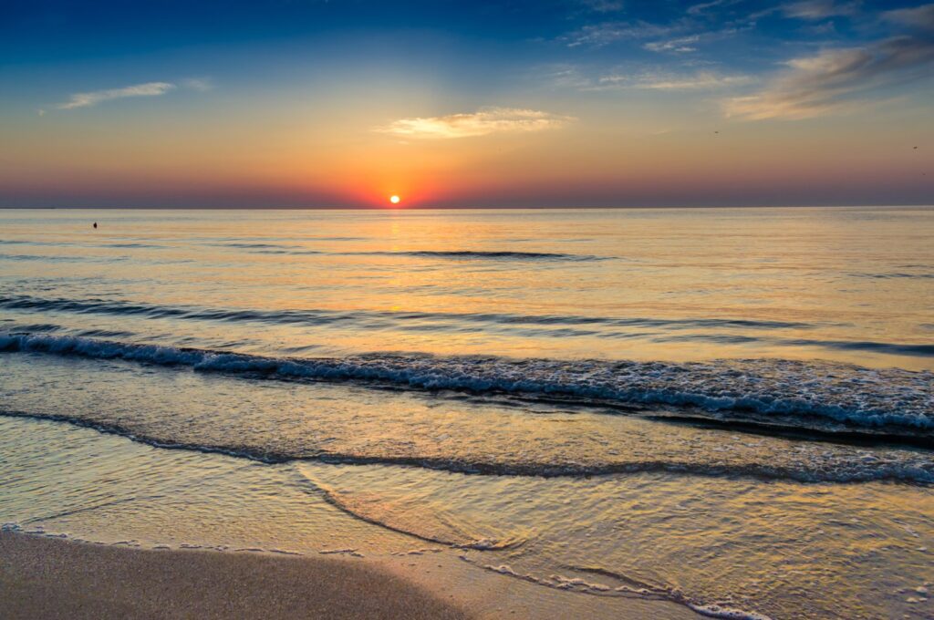 Vivid colors paint the sky as a beautiful sunrise emerges over the Black Sea, Aug. 8, 2023. (Shutterstock Photo)