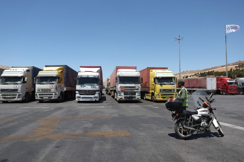 A convoy of trucks carrying humanitarian aid is seen parked after crossing the Syrian Bab al-Hawa border crossing with Türkiye, July 10, 2023. (AFP File Photo)