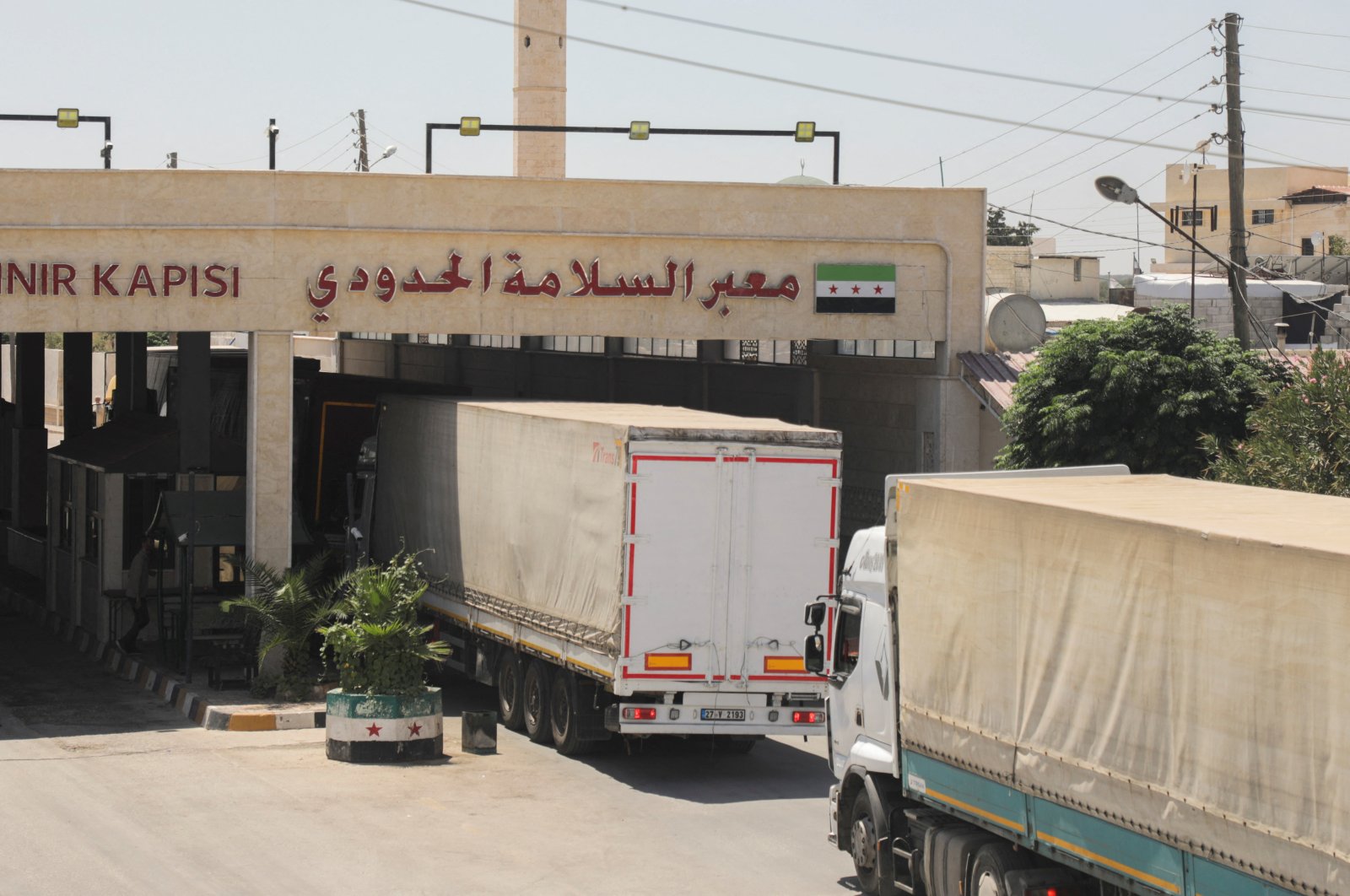 Trucks drive through the border crossing at Bab al-Salameh in Aleppo countryside, Syria, Aug. 9, 2023. (Reuters Photo)