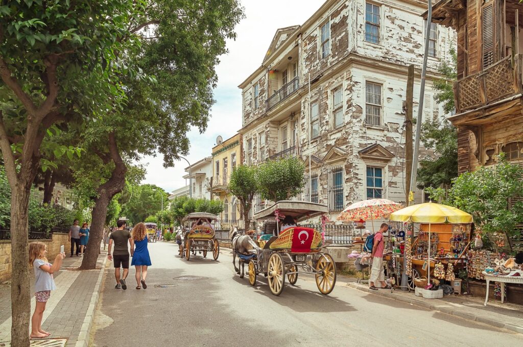 People move around the Princes' Island in horse-drawn carriages, Istanbul, Türkiye, June 30, 2018. (Shutterstock Photo)