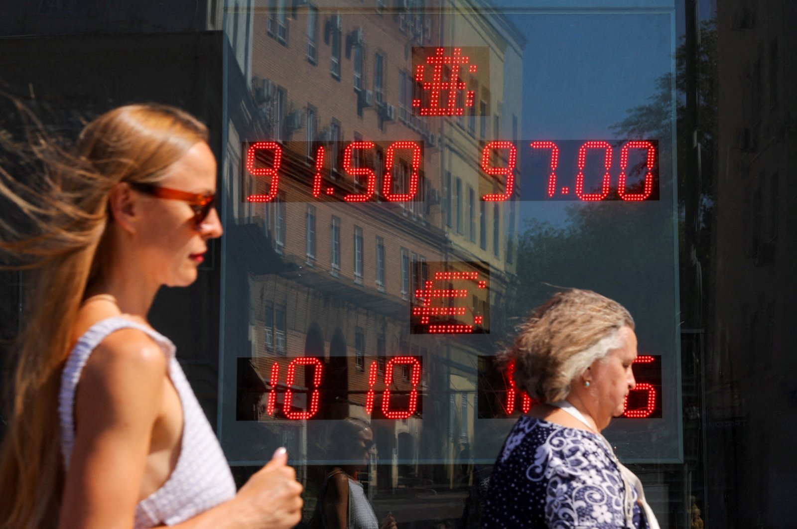 A board showing currency exchange rates of the U.S. dollar and euro against the Russian ruble is on display in a street in Moscow, Russia, Aug. 7, 2023. (Reuters Photo)