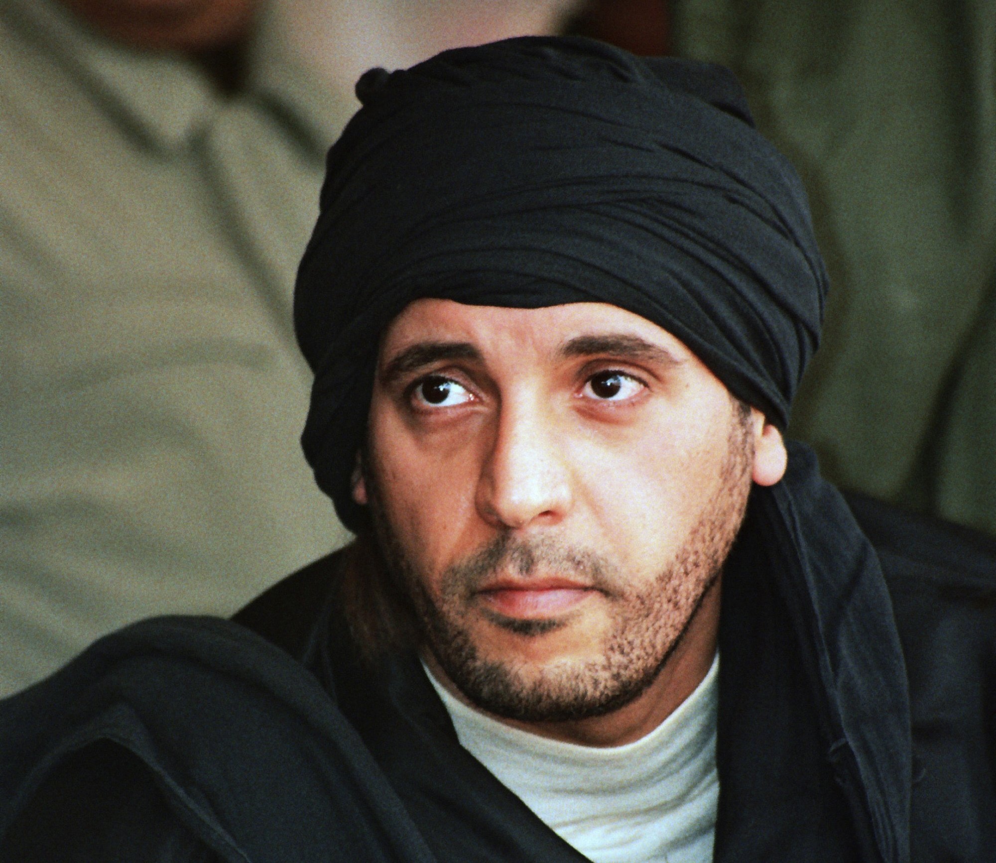 287413 Hannibal Gadhafi, son of ousted Libyan leader Moammar Gadhafi, watches an elite military unit exercise in Zlitan, Libya, Sept. 25, 2011. (AP File Photo)