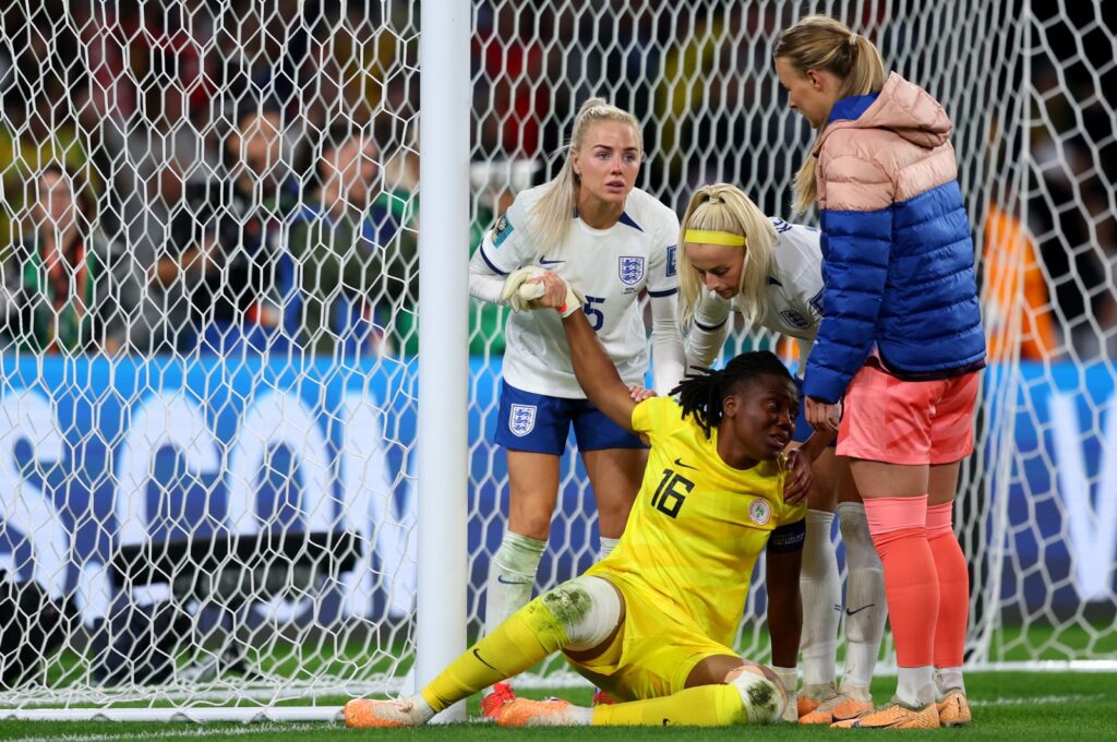 Nigeria goalkeeper Chiamaka Nnadozie of Nigeria is consoled by England players after the Women's World Cup Round of 16 match at Brisbane Stadium, Brisbane, Australia, Aug. 07, 2023. (Getty Images Photo)