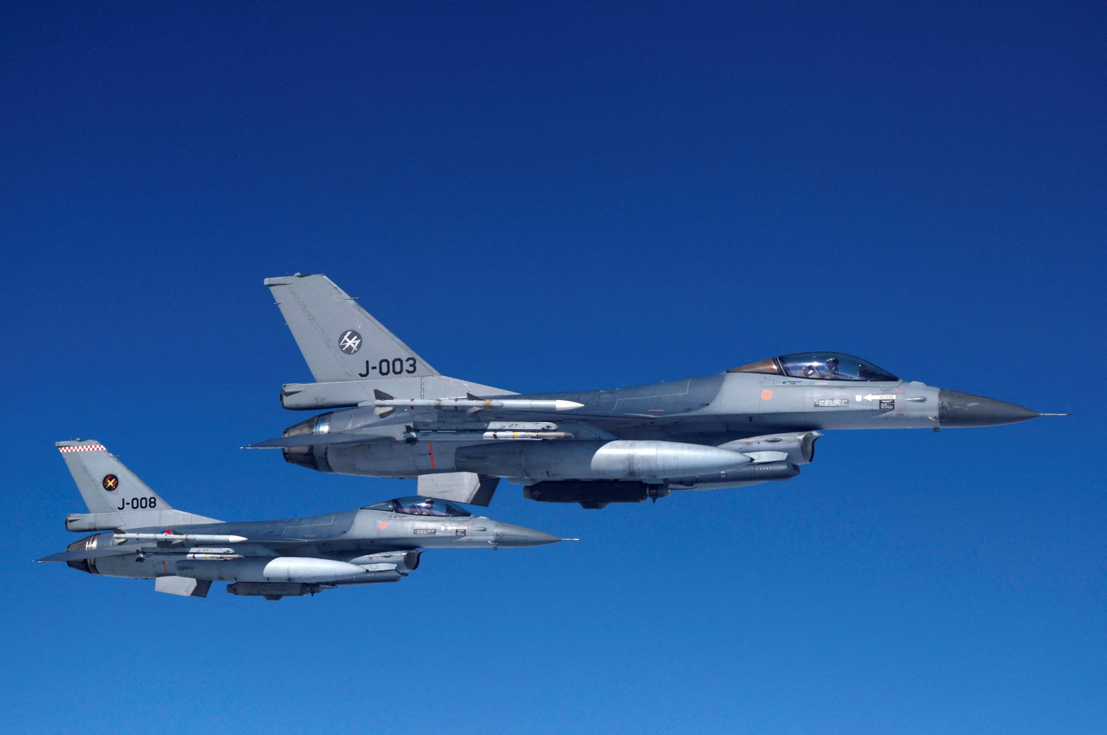 Netherlands' Air Force F-16 fighter jets fly alongside an aircraft simulating aerial interceptions during a media day illustrating how NATO Air Policing safeguards the Allies' airspace in the northern and northeastern region of the alliance, July 4, 2023. (Reuters Photo)
