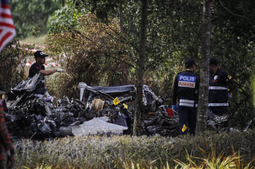 A forensic unit from the Royal Malaysia Police officers at the scene of the light aircraft crash in Elmina, Selangor, Malaysia, Aug. 17, 2023. (EPA Photo)