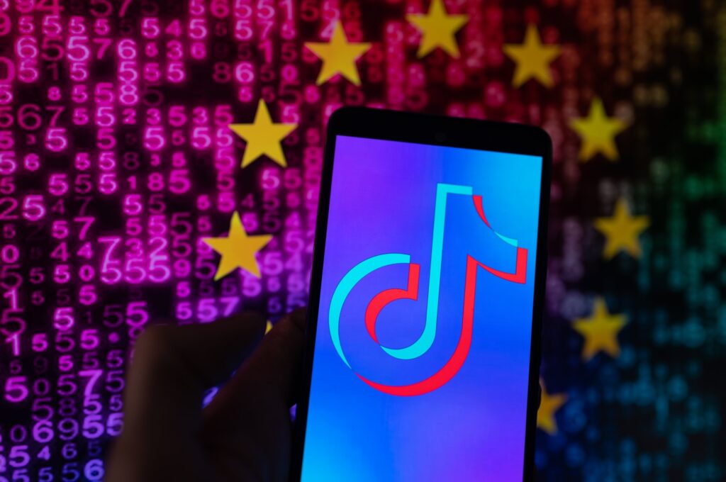 TikTok icon displayed on a phone screen with in the background European Union stars, in Brussels, Belgium, Aug. 7, 2023. (Getty Images Photo)