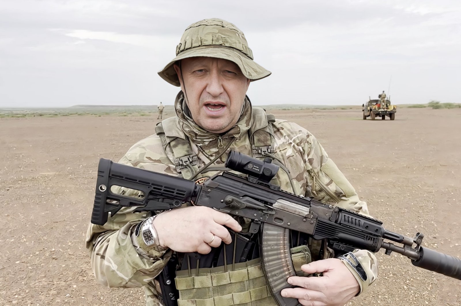 Yevgeny Prigozhin, chief of Russian private mercenary group Wagner, addresses in camouflage, with a weapon in an undisclosed desert location, in this still image from a video possibly shot in Africa, Aug. 21, 2023. (Reuters Photo)