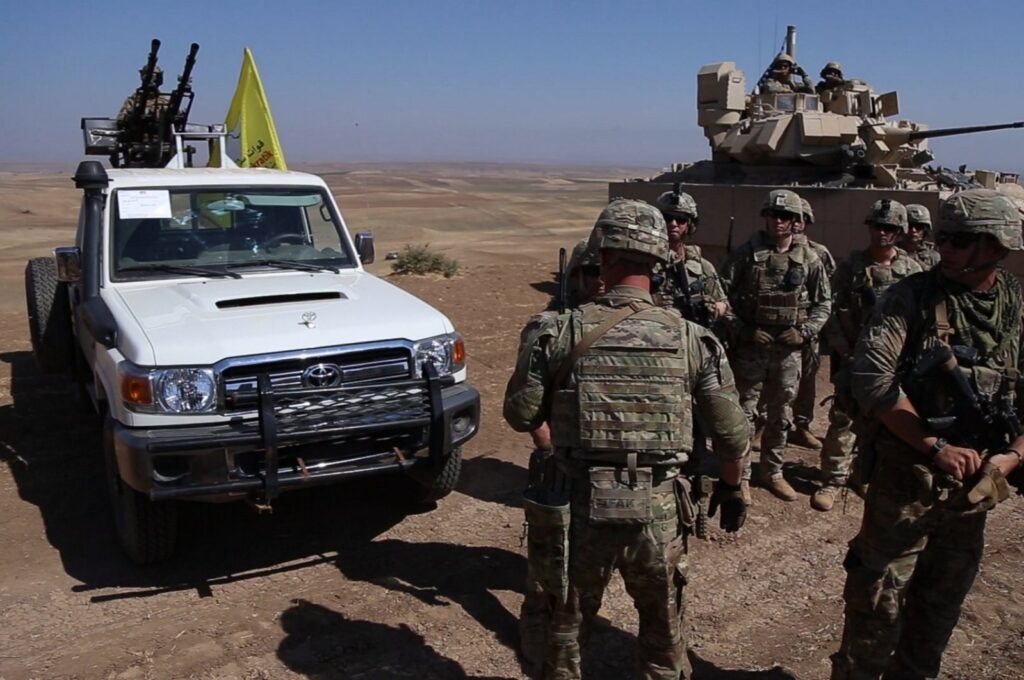 U.S. soldiers cluster as they hold a joint armed exercise with members of the YPG, the PKK terrorist group's Syrian offshoot, in the Qamishli region of Hassakeh province, northern Syria, Aug. 18, 2023. (AA Photo)