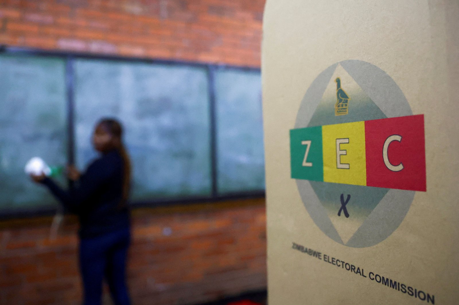 A ballot box is seen as a worker cleans a chalk board, ahead of the presidential elections in Warren Park, Harare, Zimbabwe, Aug. 22 2023. (Reuters Photo)