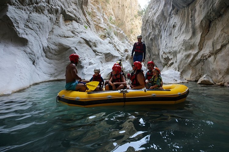A group of tourists, accompanied by a guide, transcends through chilly waters of thrilling Göynük Canyon, Antalya, southern Türkiye, Aug. 27, 2023. (AA Photo)