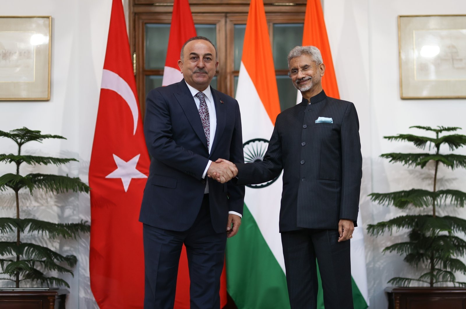 Former Foreign Minister Mevlüt Çavuşoğlu (L) and Indian Foreign Minister Subrahmanyam Jaishankar shake hands after discussions on the sidelines of G-20 foreign ministers' meeting in New Delhi, India, Feb. 28, 2023. (AA Photo)